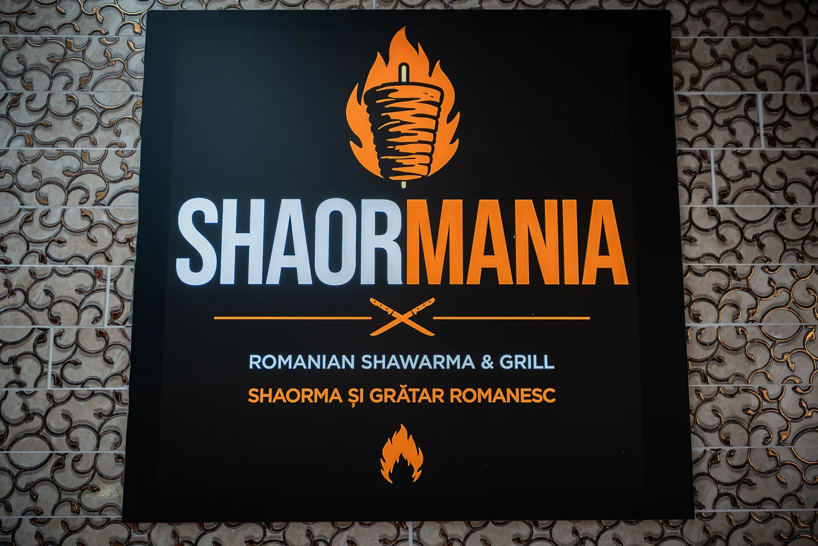 The Shaormania sign on the wall inside the restaurant in Daventry